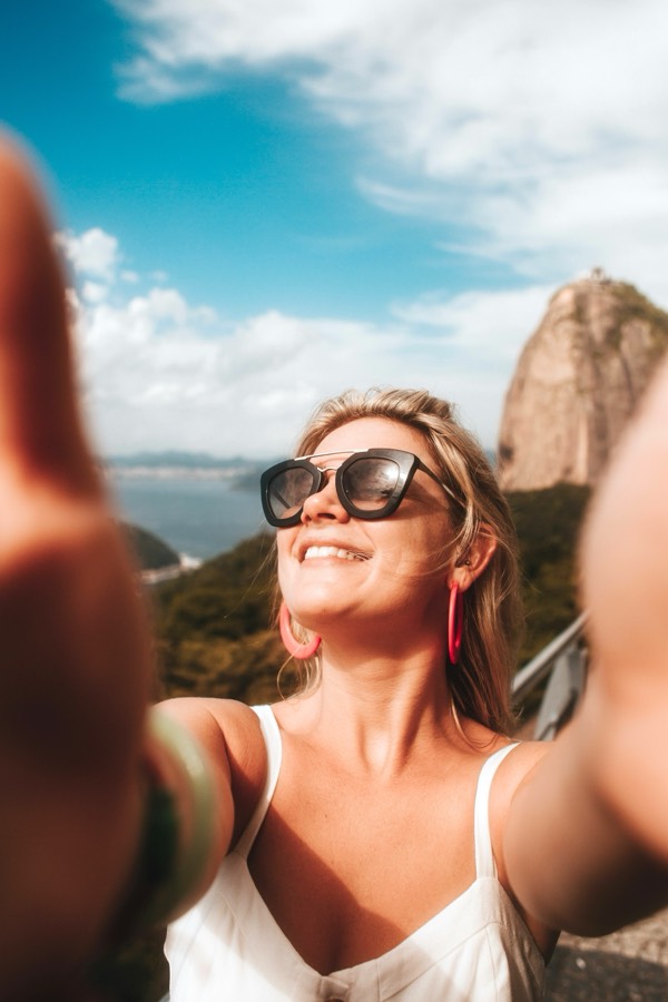 A traveller taking a selfie with the Eiffel Tower behind her